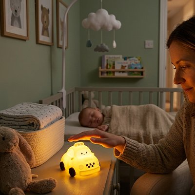 Veilleuse bebe maman qui surveille bébé qui dort illuminé par la veilleuse taxi